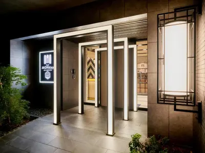 a hallway leading to a building with two doors at MONday Apart Premium AKIHABARA in Tokyo