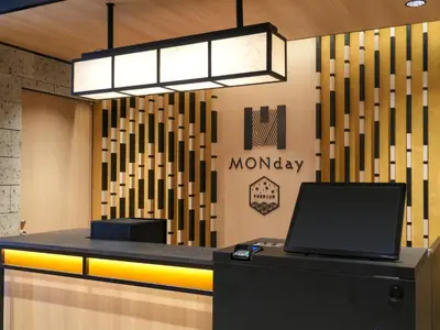 a lobby with a laptop on top of a counter at MONday Apart Premium AKIHABARA in Tokyo