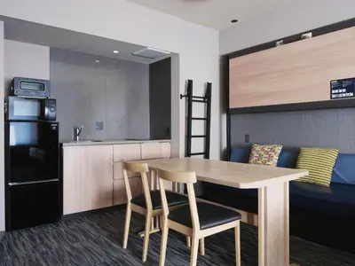a kitchen with a table and chairs in a room at MONday Apart Premium AKIHABARA in Tokyo