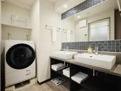 a bathroom with two sinks and a washing machine at MONday Apart Premium AKIHABARA in Tokyo