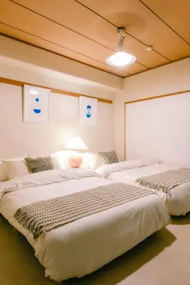 a bedroom with two beds in a room at Meee Kameari in Tokyo