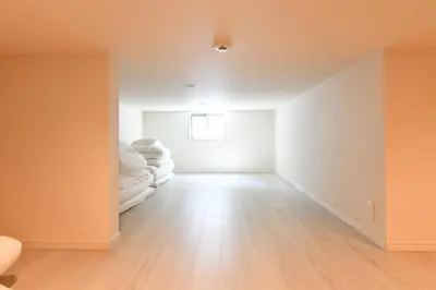 an empty room with white walls and wood floors at LacQuer House ASAKUSAⅠ in Tokyo