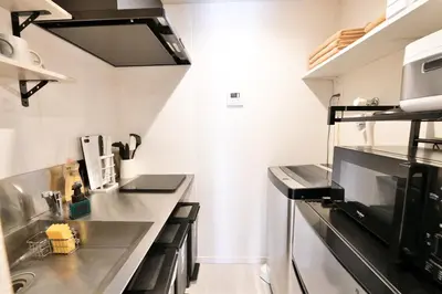 a kitchen with a stainless steel counter top at LacQuer House ASAKUSAⅠ in Tokyo