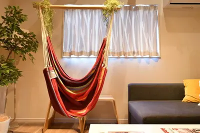 a hammock in a living room with a couch at LacQuer House ASAKUSA 2 in Tokyo
