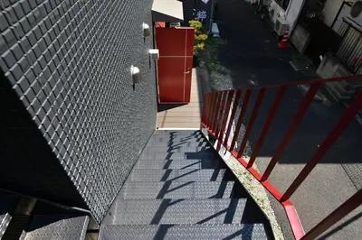 a stairway with a red fence and a building at LacQuer House ASAKUSA 2 in Tokyo