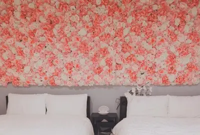 a large floral painting on the wall above two beds at LacQuer House ASAKUSA 2 in Tokyo