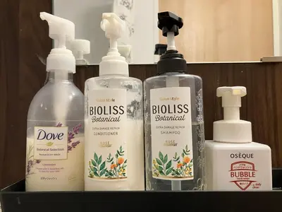 a group of three bottles of lotion on a shelf at HOTEL THE SPACE in Tokyo