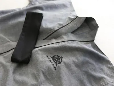 a black tie sitting on top of a gray shirt at APA Hotel Shinagawa Togoshi Ekimae in Tokyo