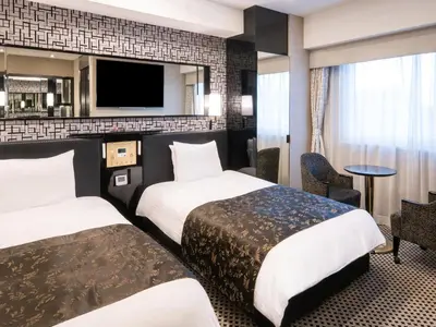 a hotel room with two beds and a flat screen tv at APA Hotel Shinagawa Togoshi Ekimae in Tokyo