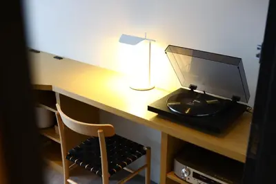 a desk with a computer monitor and a lamp on it at MUSTARD HOTEL SHIMOKITAZAWA in Tokyo