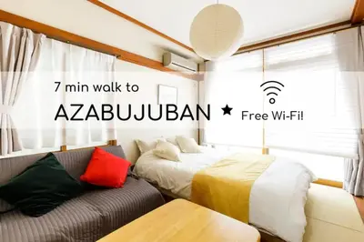 a bedroom with a bed and a couch in it at NAVI Azabujuban in Tokyo