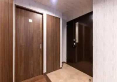 an empty room with a door and a mirror at Futaba Hotel in Tokyo