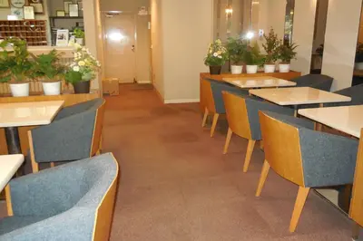 a row of tables and chairs in a restaurant at Hotel Ohedo in Tokyo