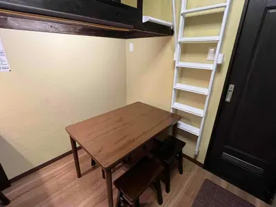 a room with a wooden table and a shelf at Japanese Modern House in Shinagawa in Tokyo