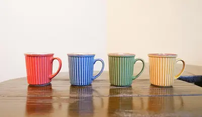 four colorful coffee mugs sitting on a table at Japanese Modern House in Shinagawa in Tokyo