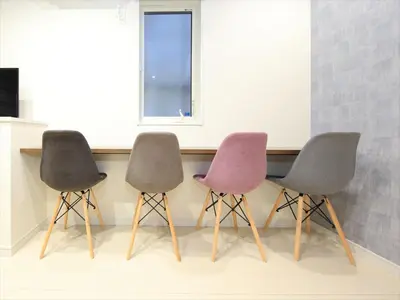 three chairs sitting next to a counter in a room at COTO Tokyo Koenji in Tokyo