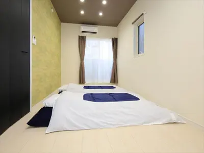 a bedroom with two beds and a window at COTO Tokyo Koenji in Tokyo