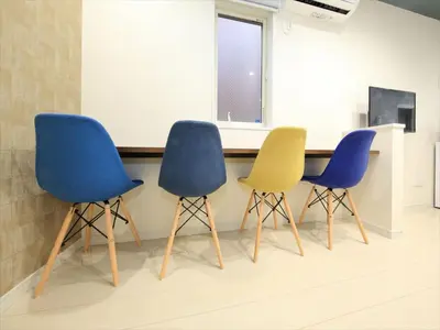 three chairs sitting next to a table in a room at COTO Tokyo Koenji in Tokyo