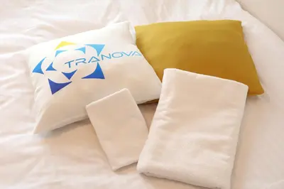 a group of pillows sitting on top of a bed at Chill Inn Honan by Tranova in Tokyo