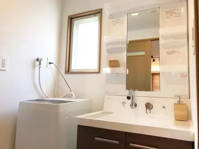 a bathroom with a sink and a mirror at Chill Inn Honan by Tranova in Tokyo