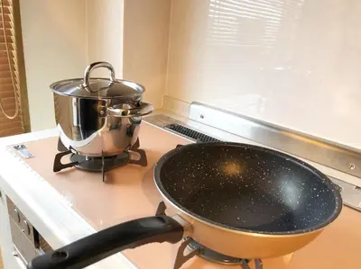 a pan on a stove with a pot on it at Chill Inn Honan by Tranova in Tokyo