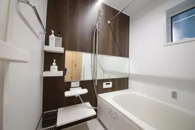 a bathroom with a tub and a sink and a shower at Sumida Base in Tokyo
