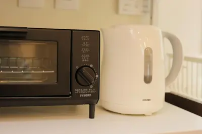 a toaster oven and a white mug next to it at Sumida Base in Tokyo
