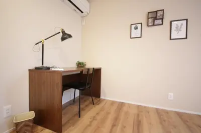a desk with a lamp and a chair in a room at Sumida Base in Tokyo