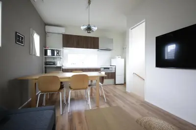a kitchen and dining room with a table and chairs at Sumida Base in Tokyo