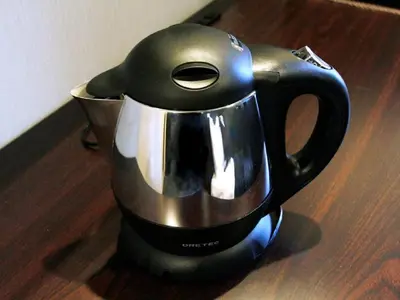 a black and silver coffee pot sitting on a table at HOTEL LiVEMAX Ikebukuro Ekimae in Tokyo