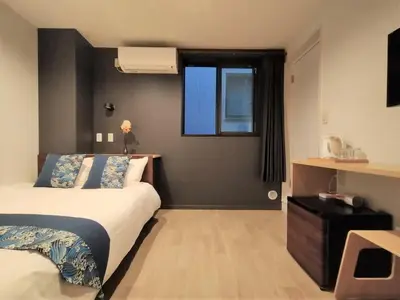 a hotel room with a bed and a window at \u6771\u4eac\u65e5\u548c in Tokyo
