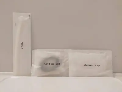 two white bags sitting on top of a bed at \u6771\u4eac\u65e5\u548c in Tokyo