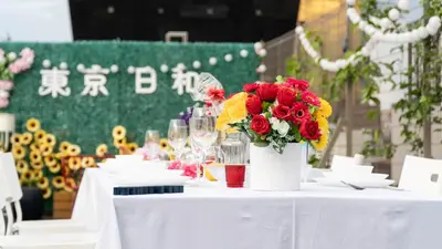 a white table with a vase of flowers on it at \u6771\u4eac\u65e5\u548c in Tokyo