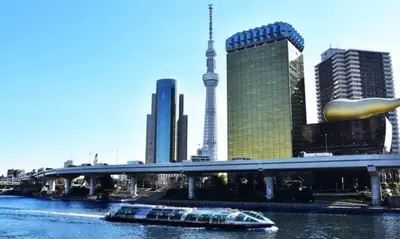 a boat on a river in a city with buildings at \u6771\u4eac\u65e5\u548c in Tokyo