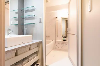 a white bathroom with a sink and a tub at HOTEL ASYL TOKYO KAMATA in Tokyo