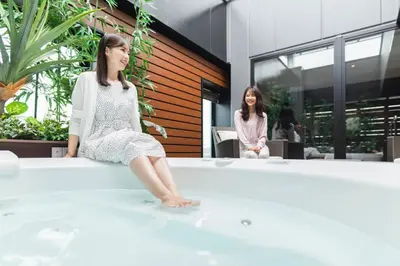 two women sitting in a bathtub in a building at HOTEL ASYL TOKYO KAMATA in Tokyo