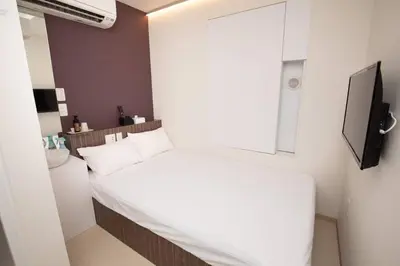 a small bedroom with a white bed and a window at Mutsumi Building - Vacation STAY 00543v in Tokyo