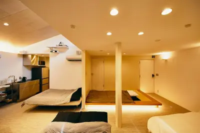 a bedroom with two beds in a room with a kitchen at 634 Condo Shinjuku - Vacation STAY 01910v in Tokyo