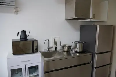 a small kitchen with a sink and a refrigerator at 634 Condo Shinjuku - Vacation STAY 01910v in Tokyo