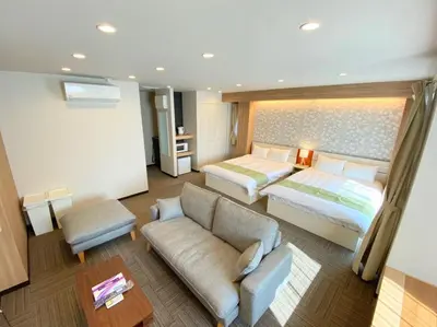 a hotel room with a bed and a couch and a bed and a table at winco - Vacation STAY 05557v in Tokyo