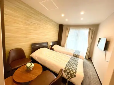 a hotel room with two beds and a table and chairs at winco - Vacation STAY 06648v in Tokyo
