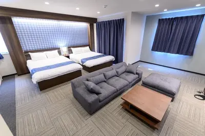a hotel room with two beds and a couch at winco - Vacation STAY 06658v in Tokyo