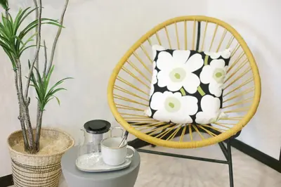 a yellow chair with a black and white pillow on it at Green Sea Oshiage in Tokyo