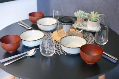 a black table with bowls and glasses on it at Green Sea Oshiage in Tokyo