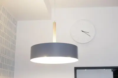 a white light fixture and a clock on a wall at Green Sea Oshiage in Tokyo