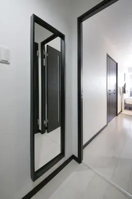 a mirror on a wall in a room at Green Sea Oshiage in Tokyo