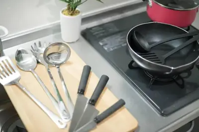 a frying pan on top of a stove with utensils at Green Sea Oshiage in Tokyo