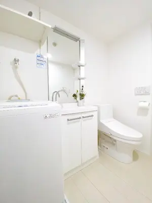 a white bathroom with a toilet and a sink at nestay apartment tokyo ginza in Tokyo