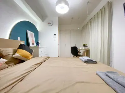a bedroom with a large bed and a desk at nestay apartment tokyo ginza in Tokyo