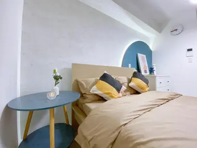 a bedroom with a bed and a blue table at nestay apartment tokyo ginza in Tokyo